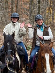 Cindy McGarvey riding horses with her sister